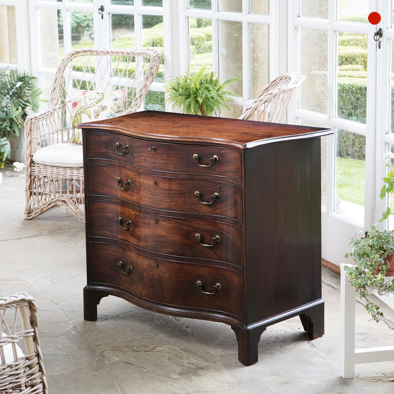 A fine George III mahogany serpentine chest of drawers in the manor of Henry Hill of Marlborough 1