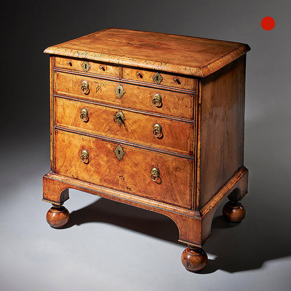 An extremely rare George I walnut chest of small proportions on ball and bracket