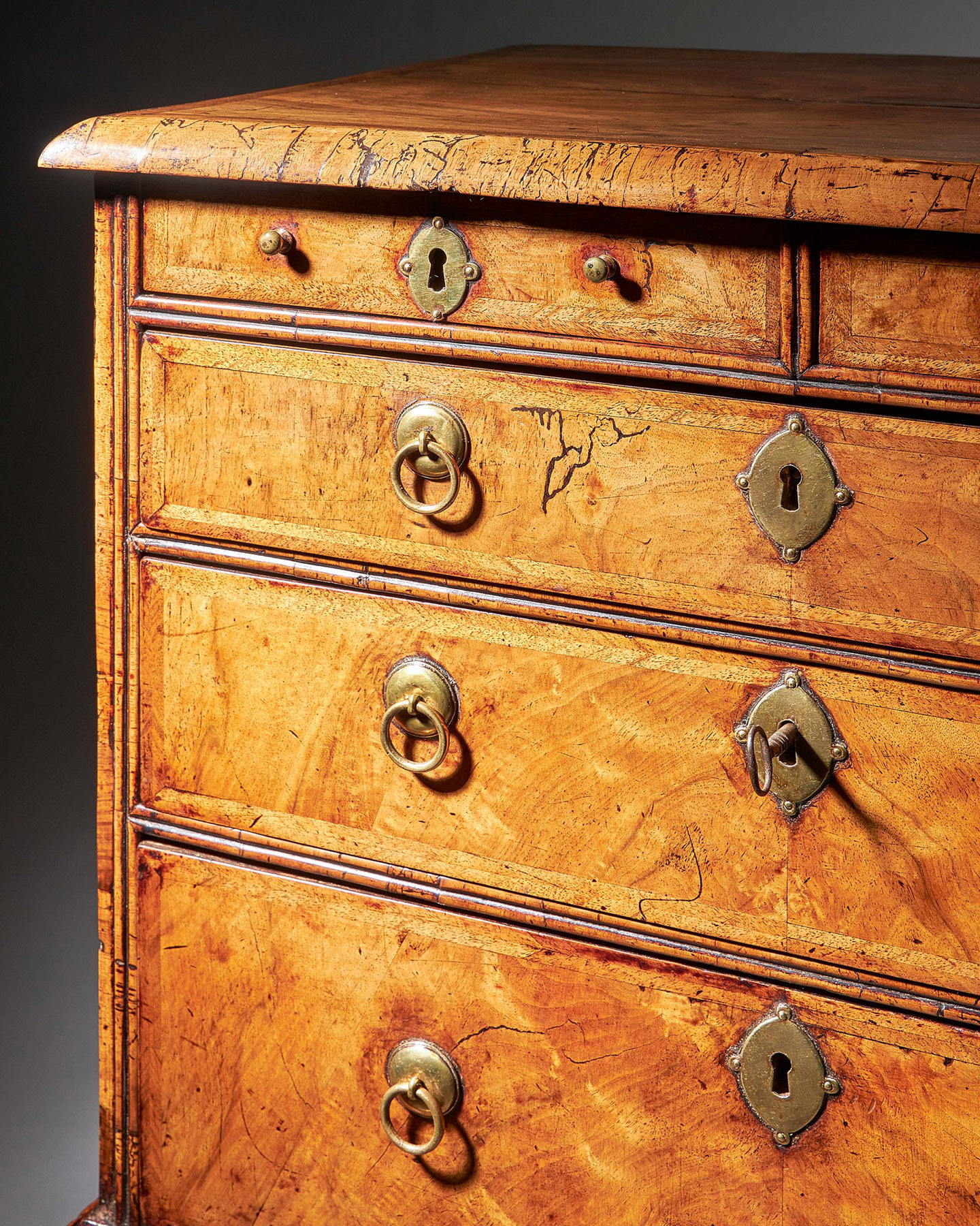 An extremely rare George I walnut chest of small proportions on ball and bracket 10