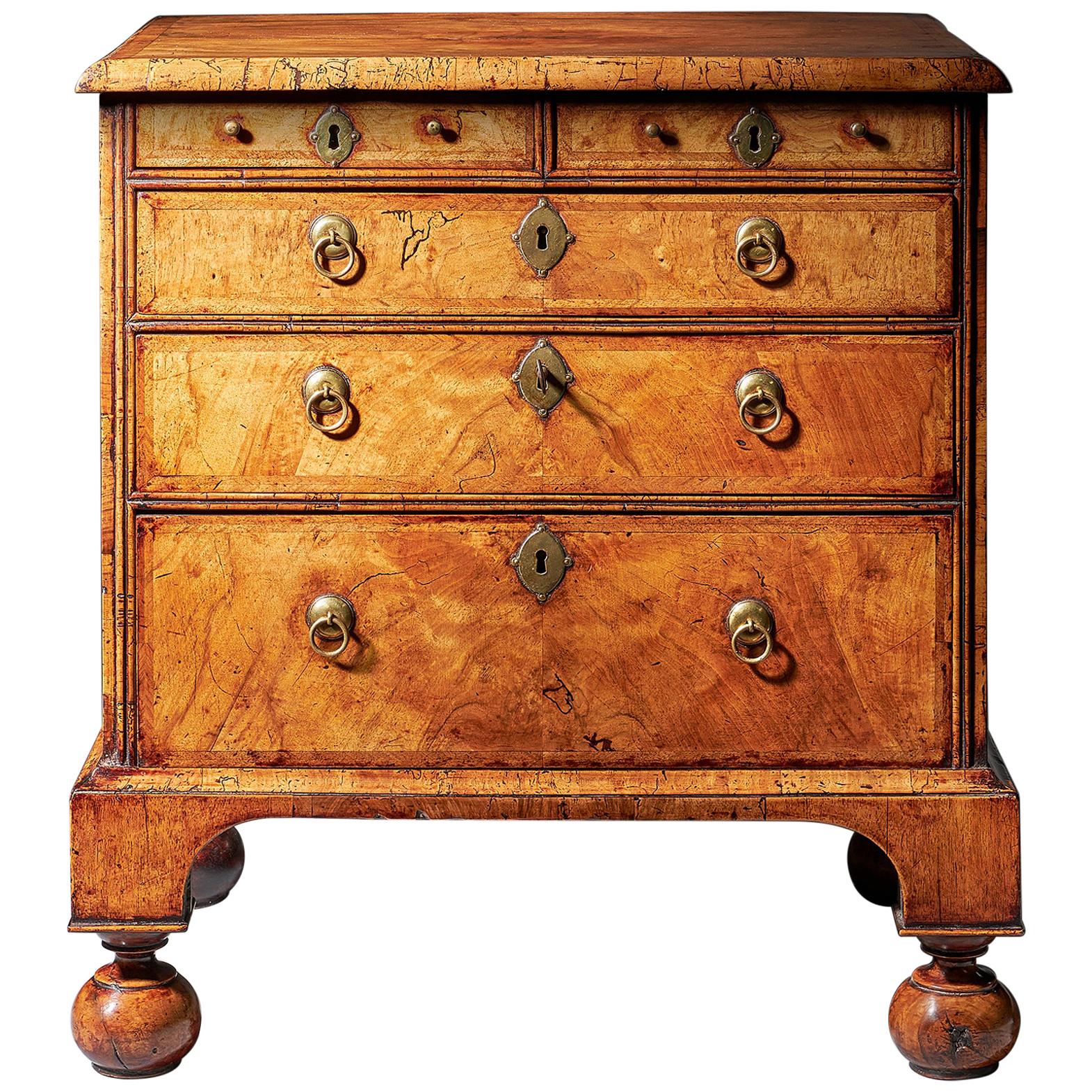 An extremely rare George I walnut chest of small proportions on ball and bracket 15