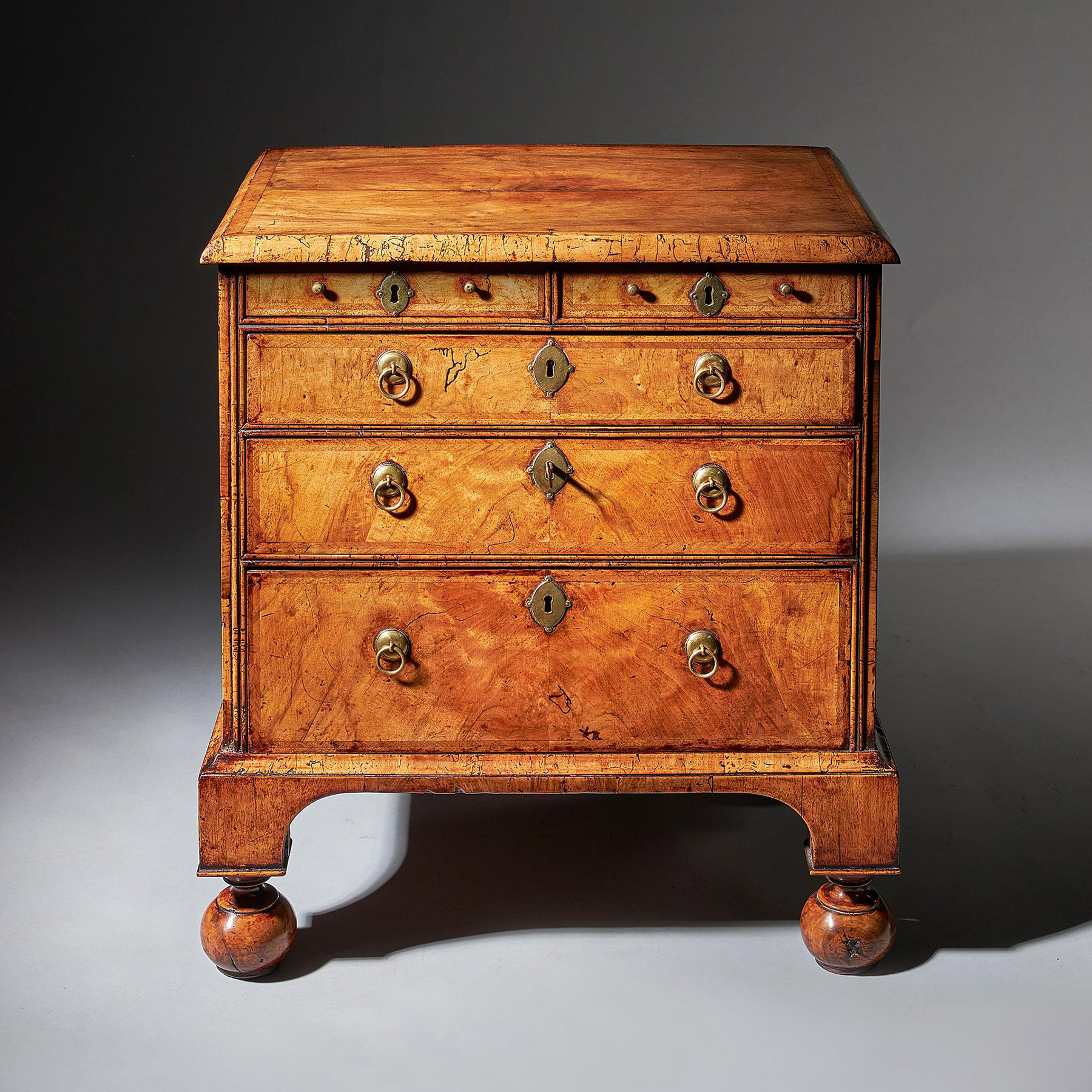 An extremely rare George I walnut chest of small proportions on ball and bracket 3