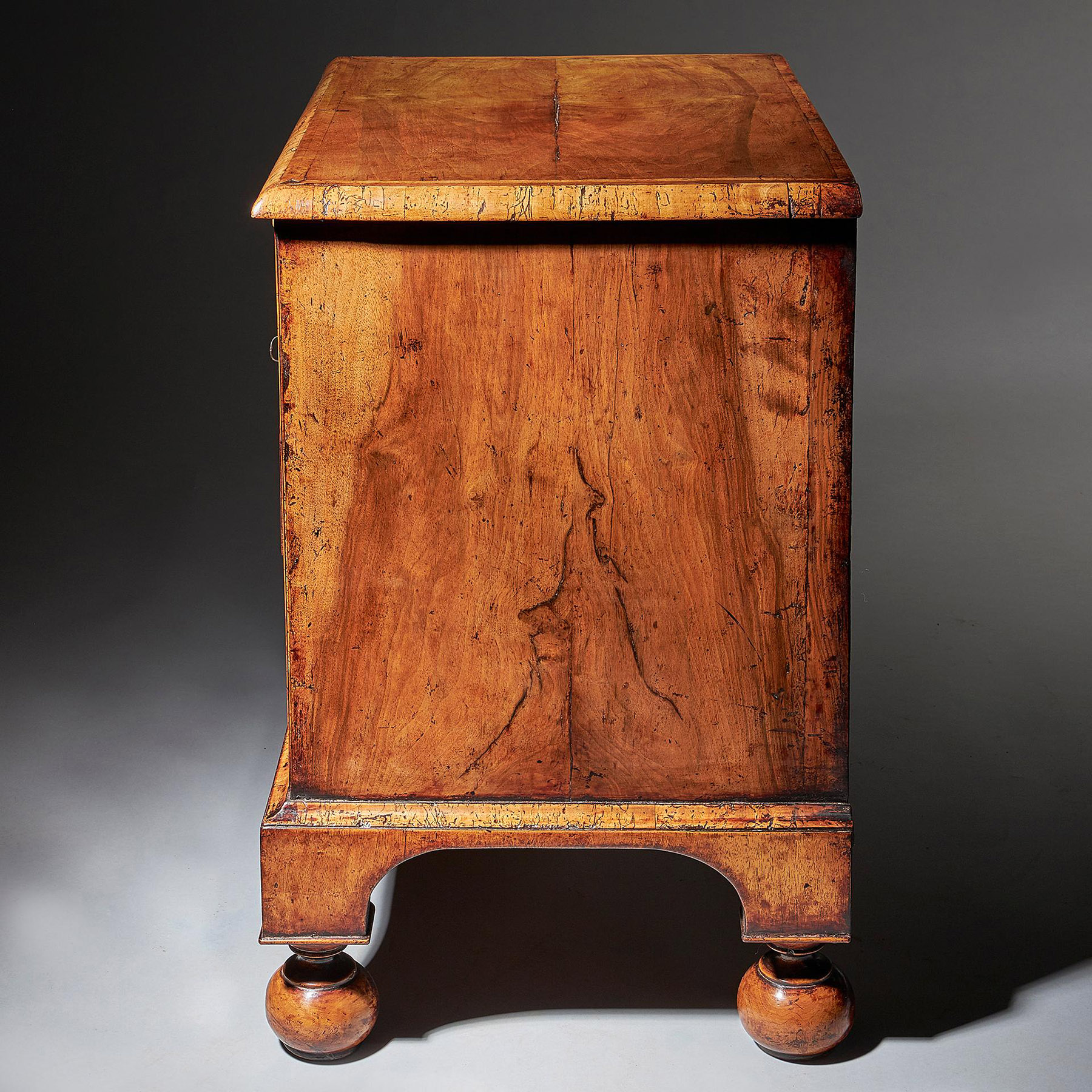 An extremely rare George I walnut chest of small proportions on ball and bracket 4