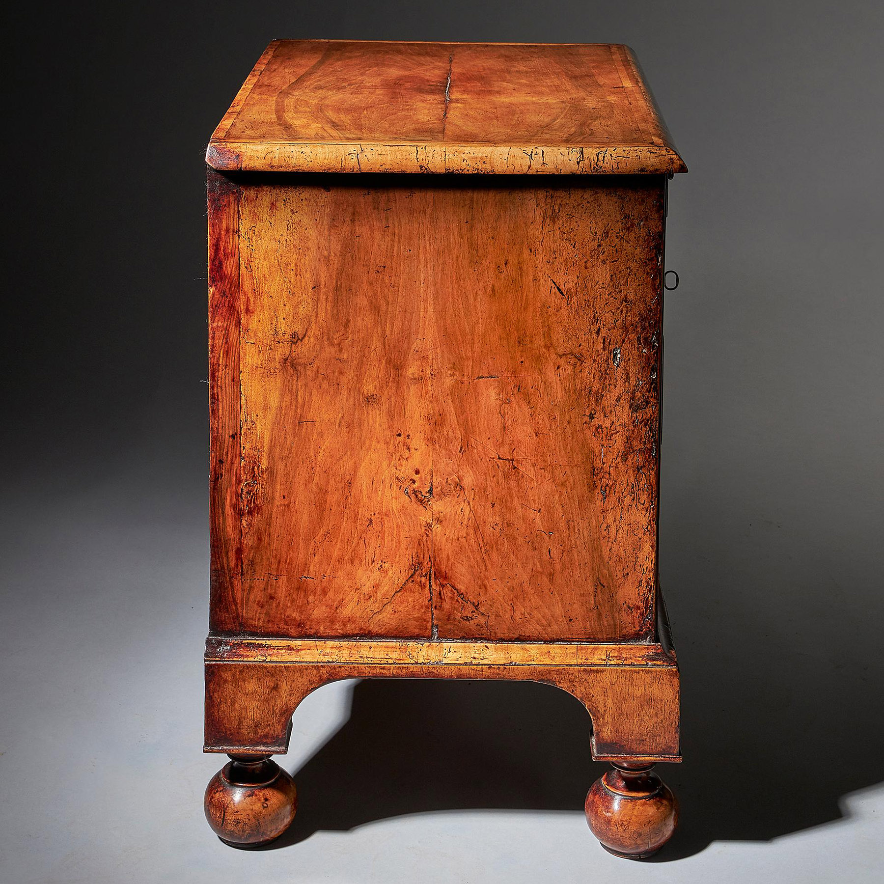 An extremely rare George I walnut chest of small proportions on ball and bracket 5