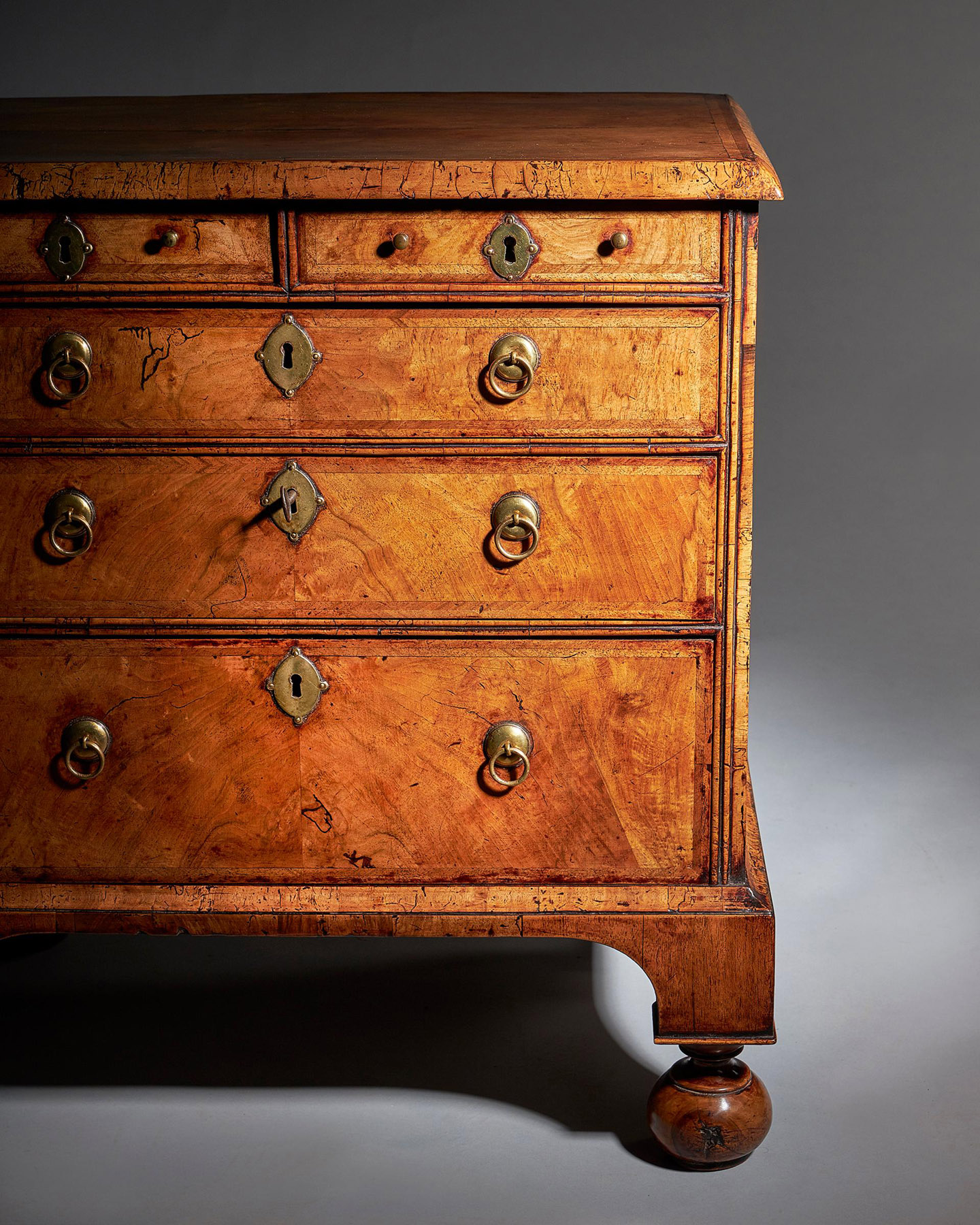 An extremely rare George I walnut chest of small proportions on ball and bracket 8