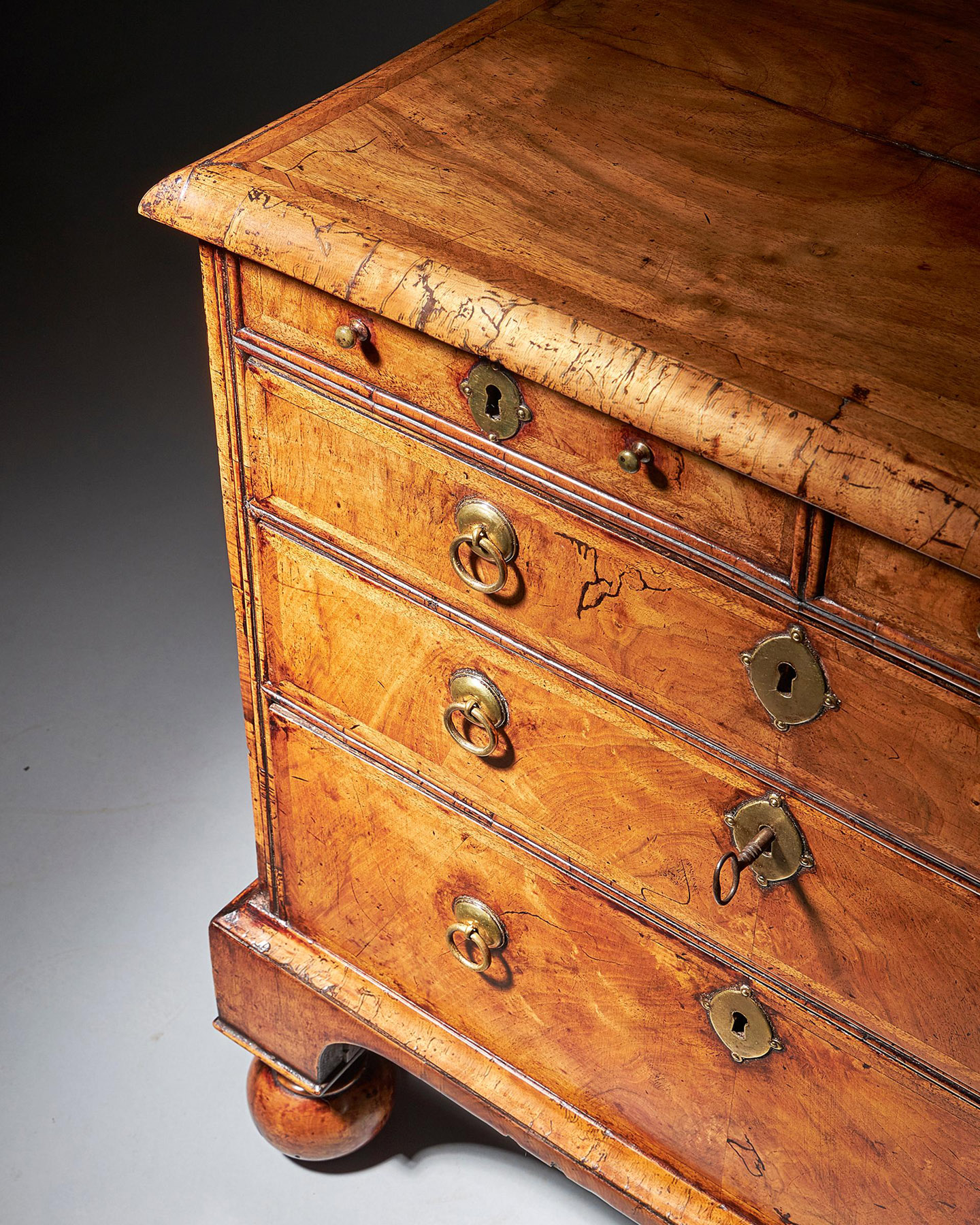 An extremely rare George I walnut chest of small proportions on ball and bracket 9