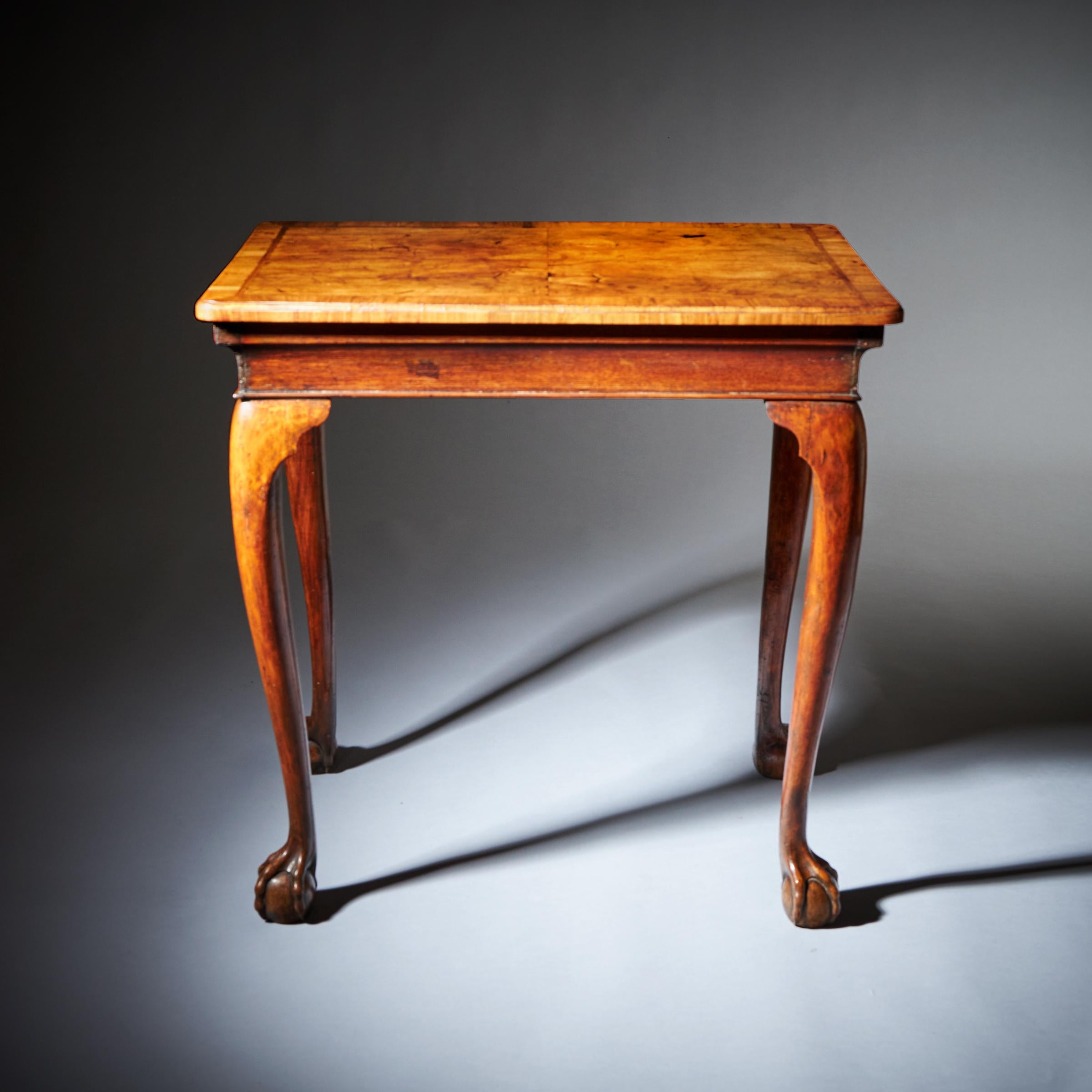 Lot - A George I style walnut serpentine side table 1930s, the cross banded  moulded top over a single drawer
