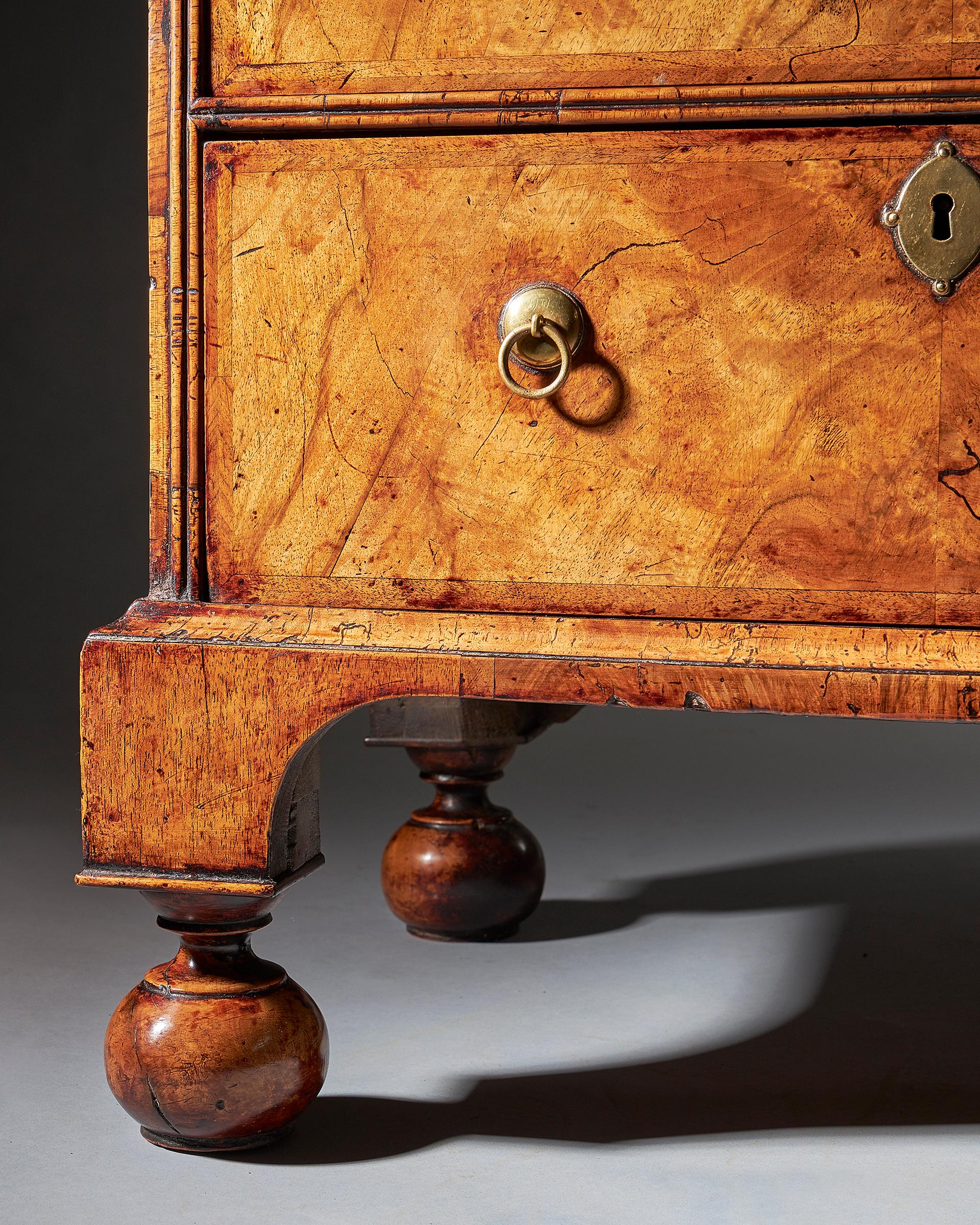 An extremely rare George I walnut chest of small proportions on ball and bracket 12