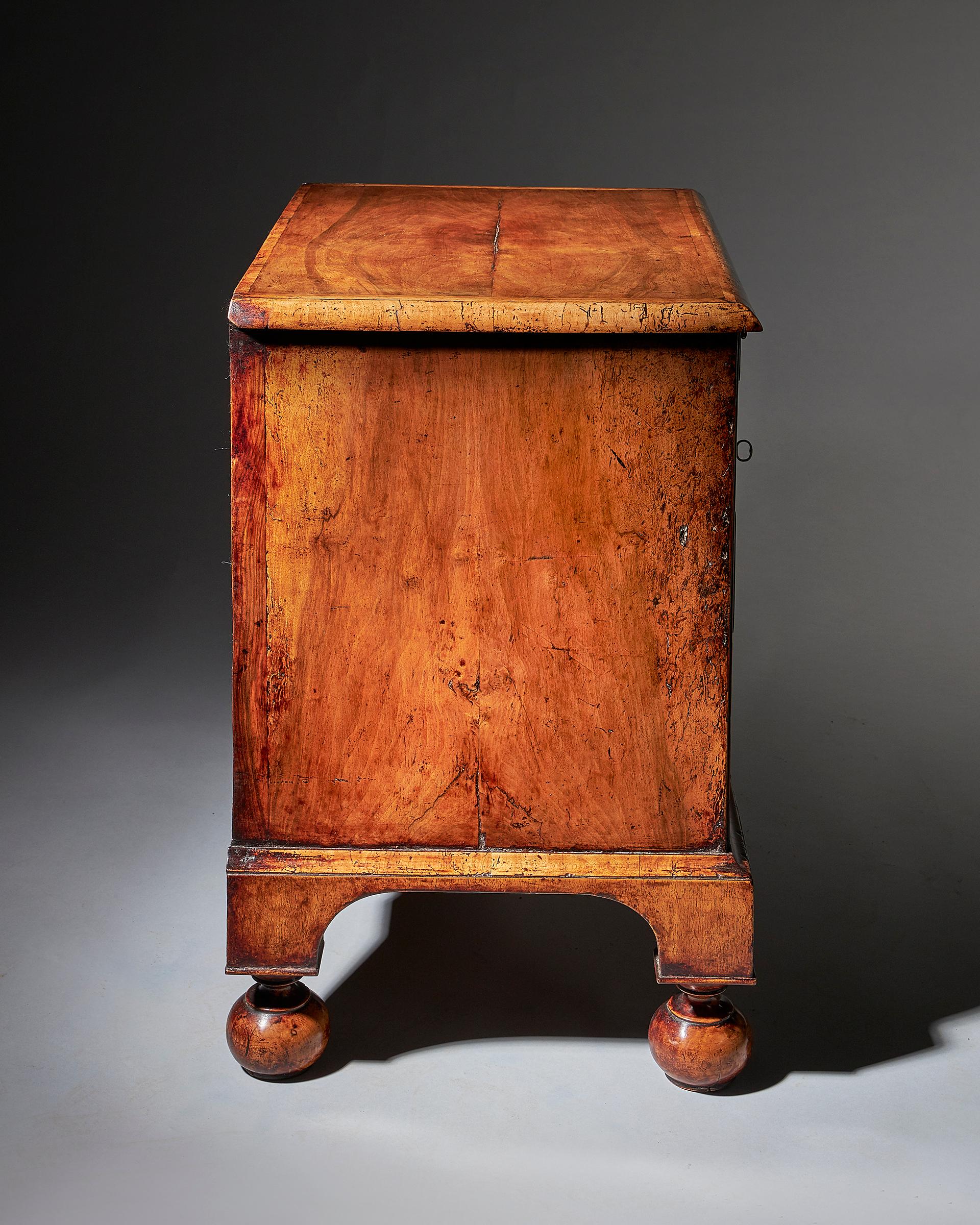 An extremely rare George I walnut chest of small proportions on ball and bracket 5