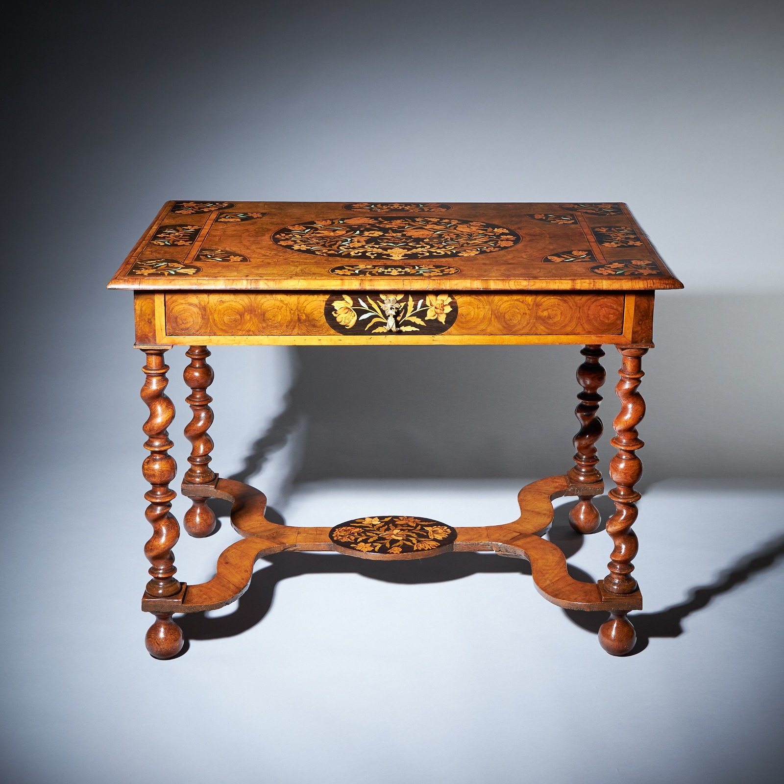 The important floral marquetry inlaid olive oyster and ebony table. 2